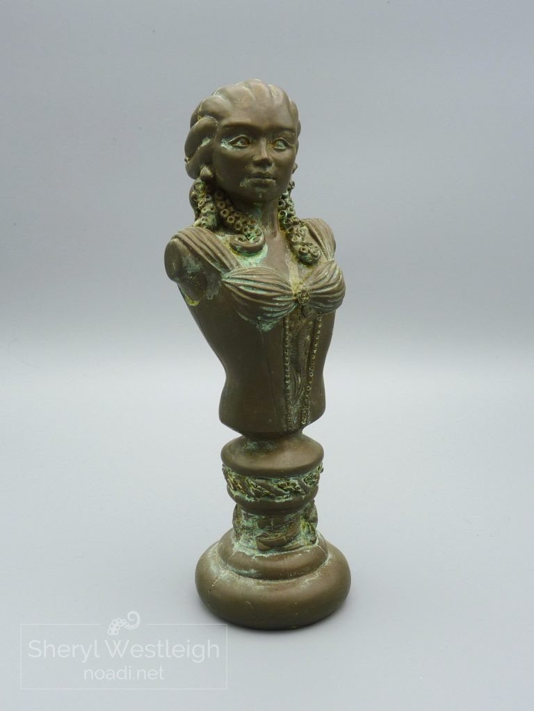 Cold Cast Bronze bust of a woman with pale skin and blue tentacles instead of heair.