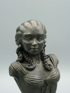 Cold Cast Steel bust of a woman with pale skin and blue tentacles instead of heair.